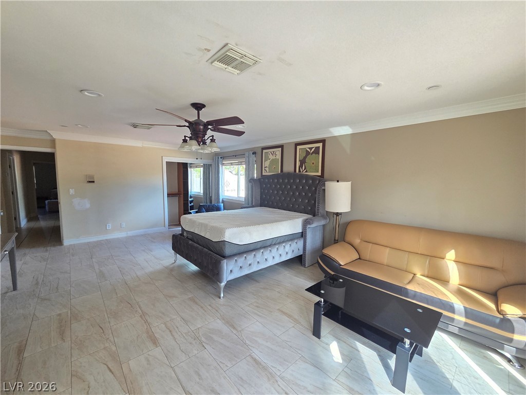 3381 Westwind Road Las Vegas, NV 89146 - Photo 40 of 52 Ceramic tile flooring spans this generously sized bedroom, illuminated by recessed lighting and a ceiling fan.