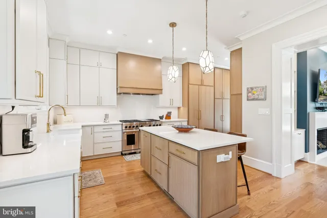 a view of a hallway with a livingroom and a hall with wooden floor