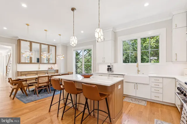 a living room with furniture a fireplace and a large window