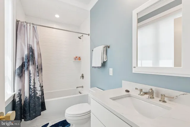 a white toilet sitting next to a bathroom sink