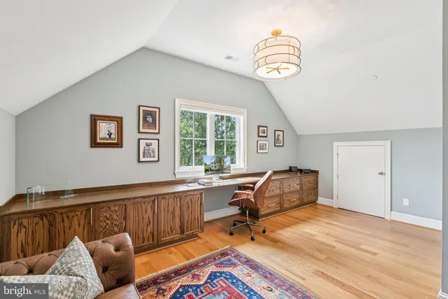 a room with table chairs and wooden floor