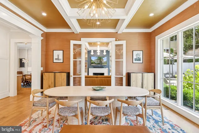 a view of a dining room with furniture wooden floor and chandelier