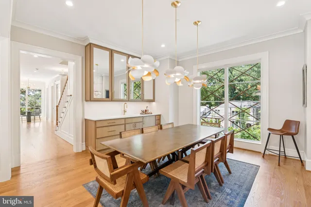 a dining room with furniture and large windows