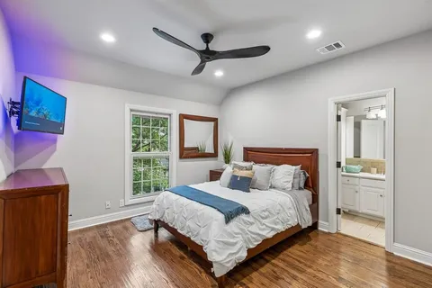 a bedroom with a large bed and a window