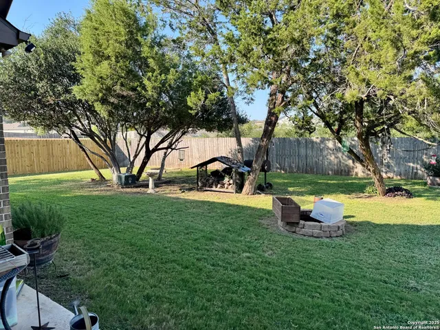 a view of a house with backyard and sitting area