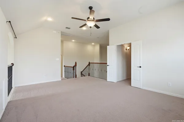 a view of an empty room with a ceiling fan
