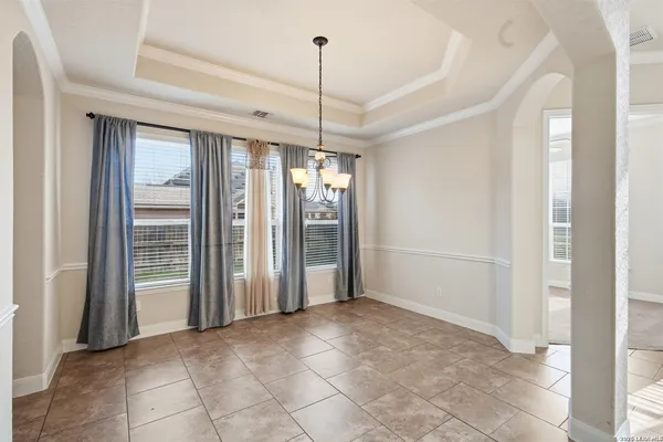 a view of a room with windows and entryway