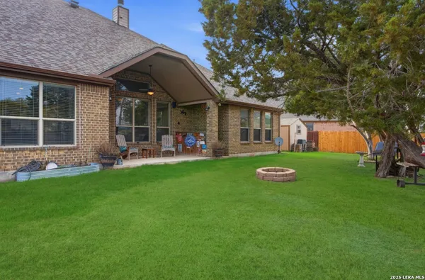 a view of an house with backyard space and porch