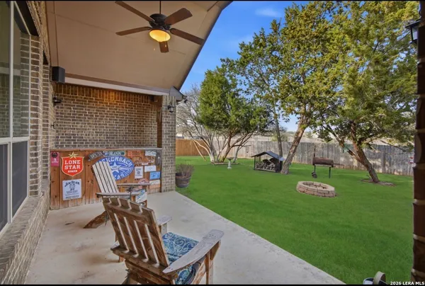 a view of a chairs and table in backyard of the house