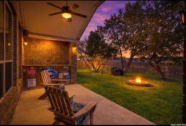 a view of a chairs and table in patio