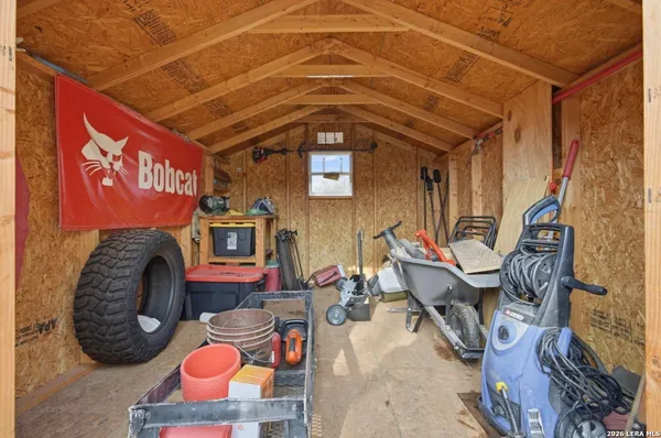 a view of a chairs with potted plants in front of main door