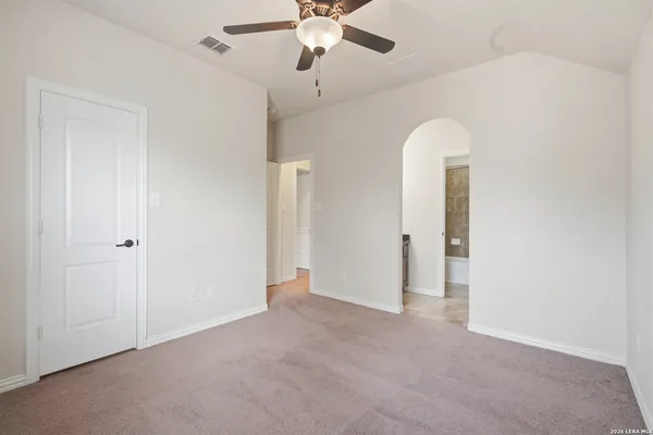 a view of an empty room with a ceiling fan