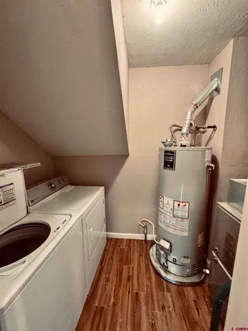 a view of a kitchen with a sink and wooden floor