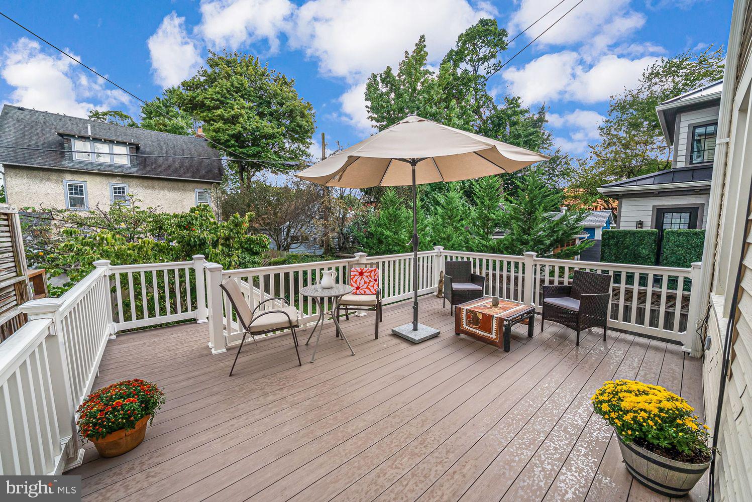 3614 Ordway Street Northwest Washington, DC 20016 - Photo 17 of 81 a view of a chairs and table on the wooden deck