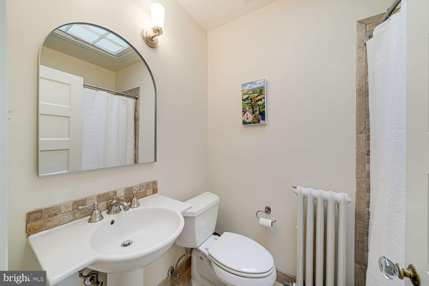 3614 Ordway Street Northwest Washington, DC 20016 - Photo 29 of 81 a bathroom with a sink a toilet and mirror