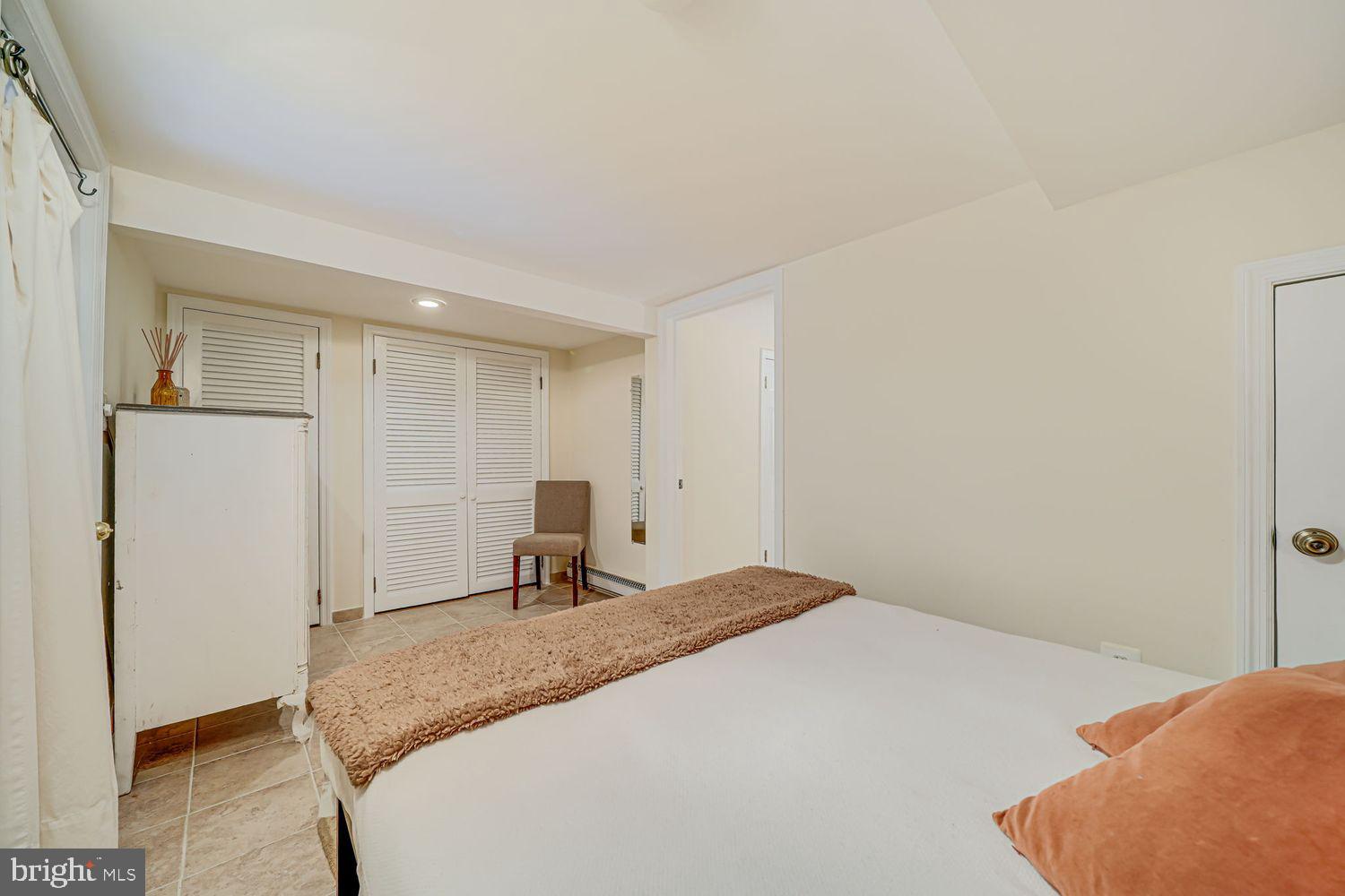 3614 Ordway Street Northwest Washington, DC 20016 - Photo 47 of 81 a bedroom with a bed and a refrigerator