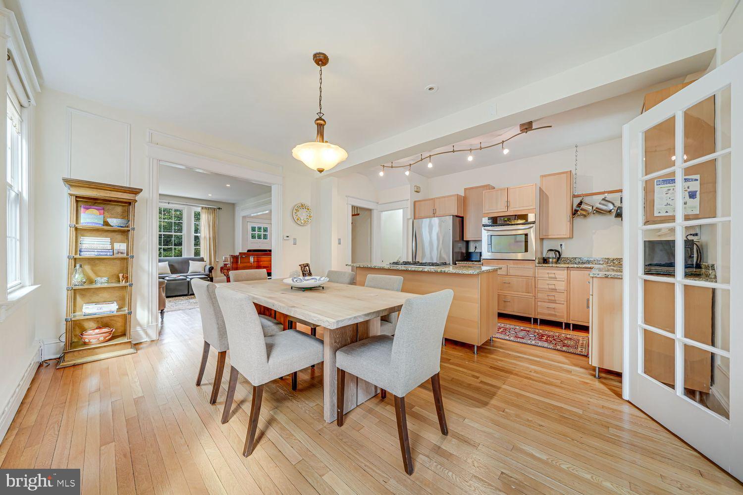 3614 Ordway Street Northwest Washington, DC 20016 - Photo 8 of 81 a view of a dining room and livingroom with furniture wooden floor a chandelier