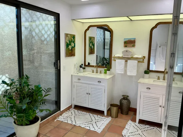 a room with painting and a potted plant