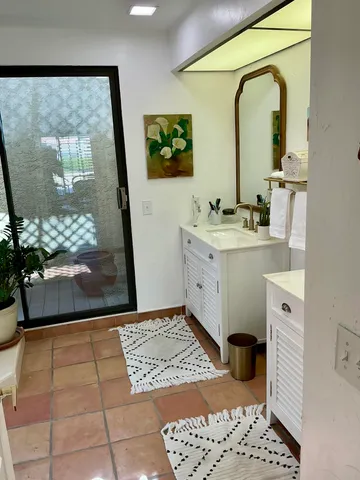 a bathroom with a sink a mirror and a shower