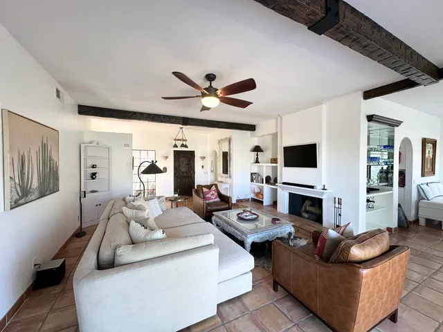 a living room with furniture kitchen view and a fireplace