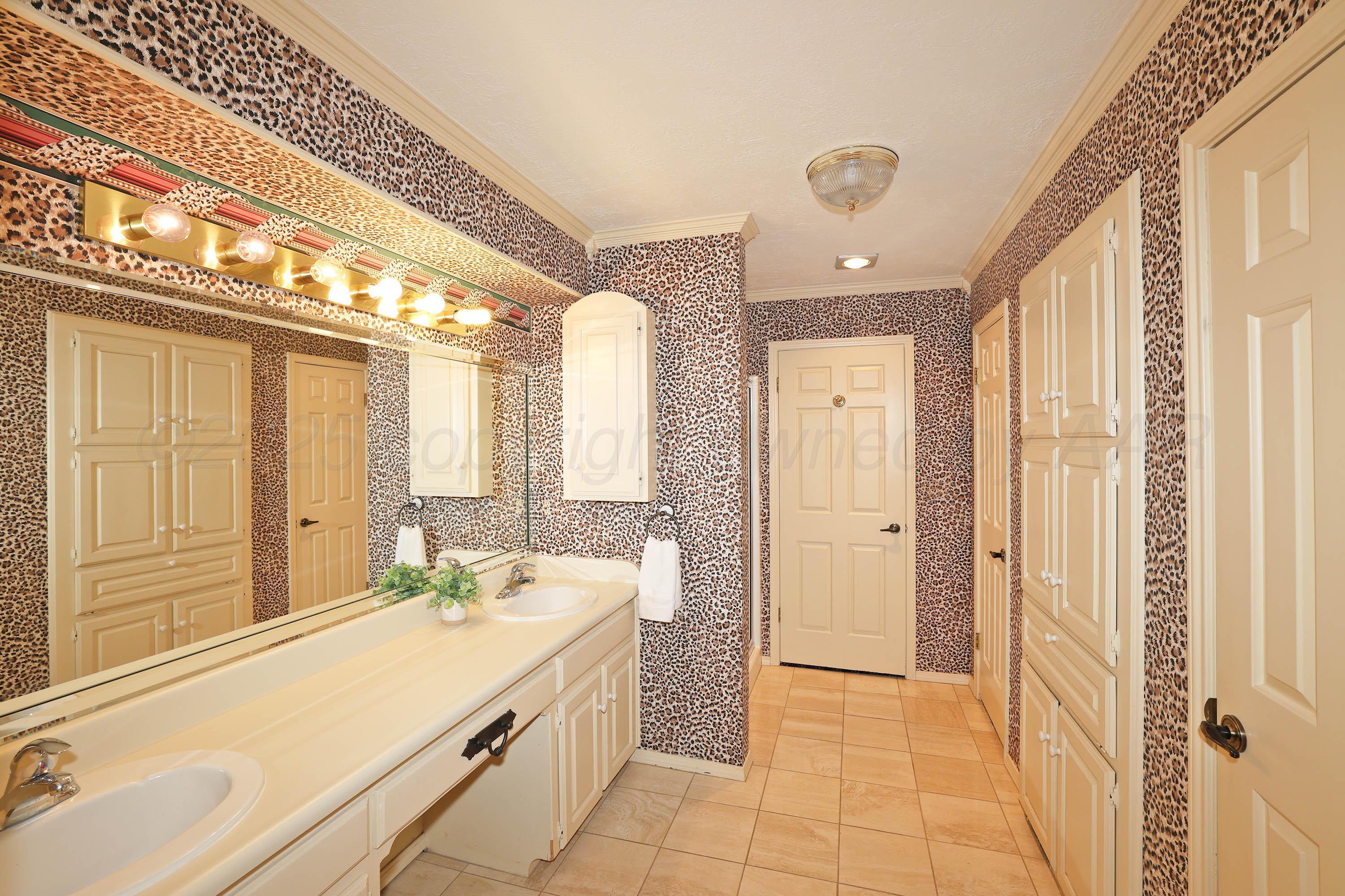 1615 South Bryan Street, Unit 19 Amarillo, TX 79102 - Photo 23 of 53 a spacious bathroom with a double vanity sink a mirror and a shower
