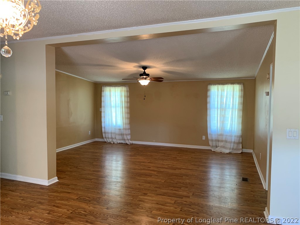 228 L A Sandy Road Raeford, NC 28376 - Photo 17 of 36 a view of an empty room with wooden floor and a window