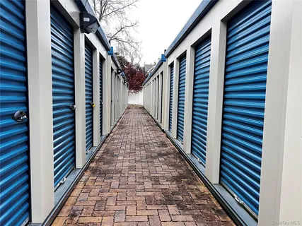 a view of a back yard with wooden fence