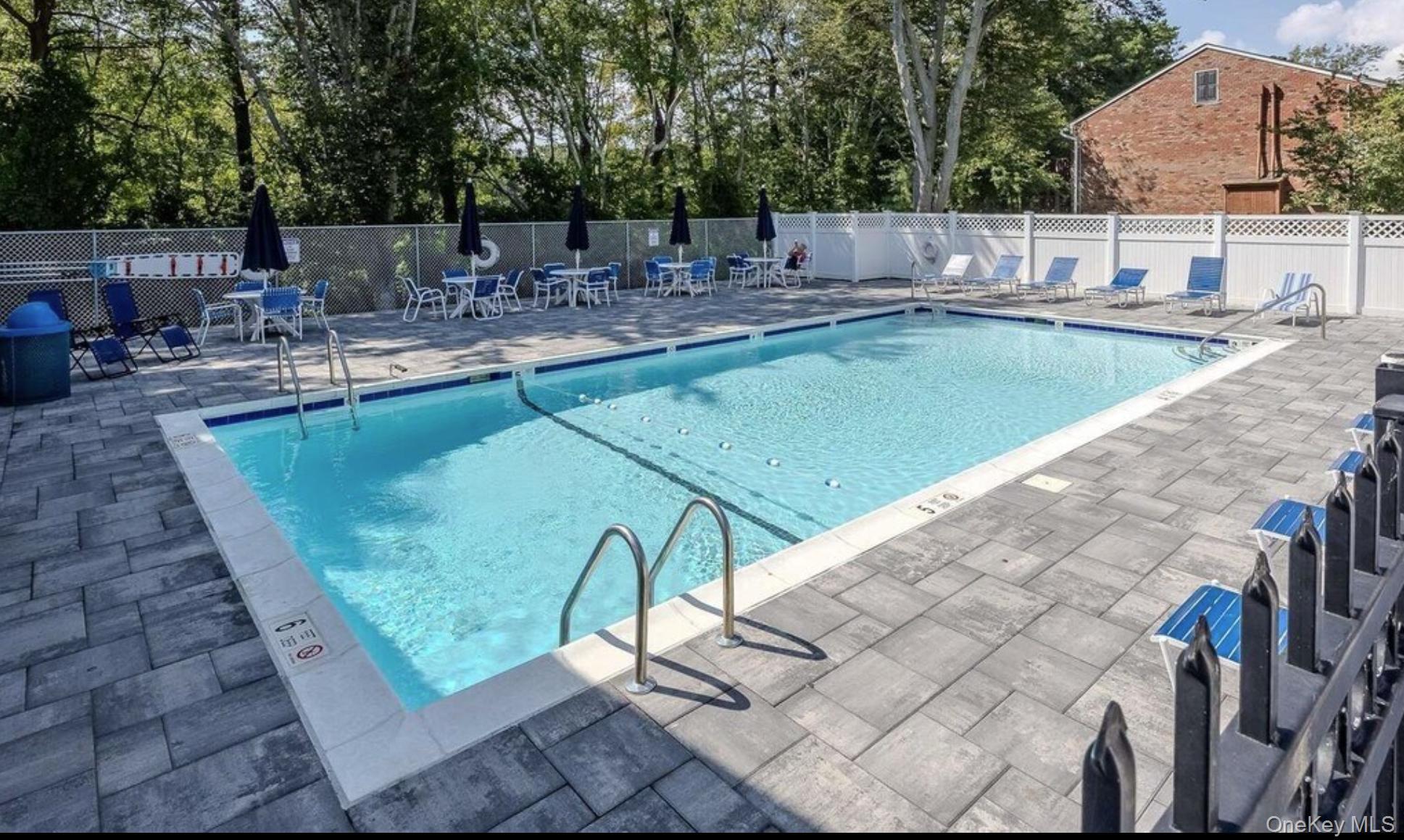 40 West 4th Street, Unit 149 Patchogue, NY 11772 - Photo 15 of 15 a view of a swimming pool with a patio
