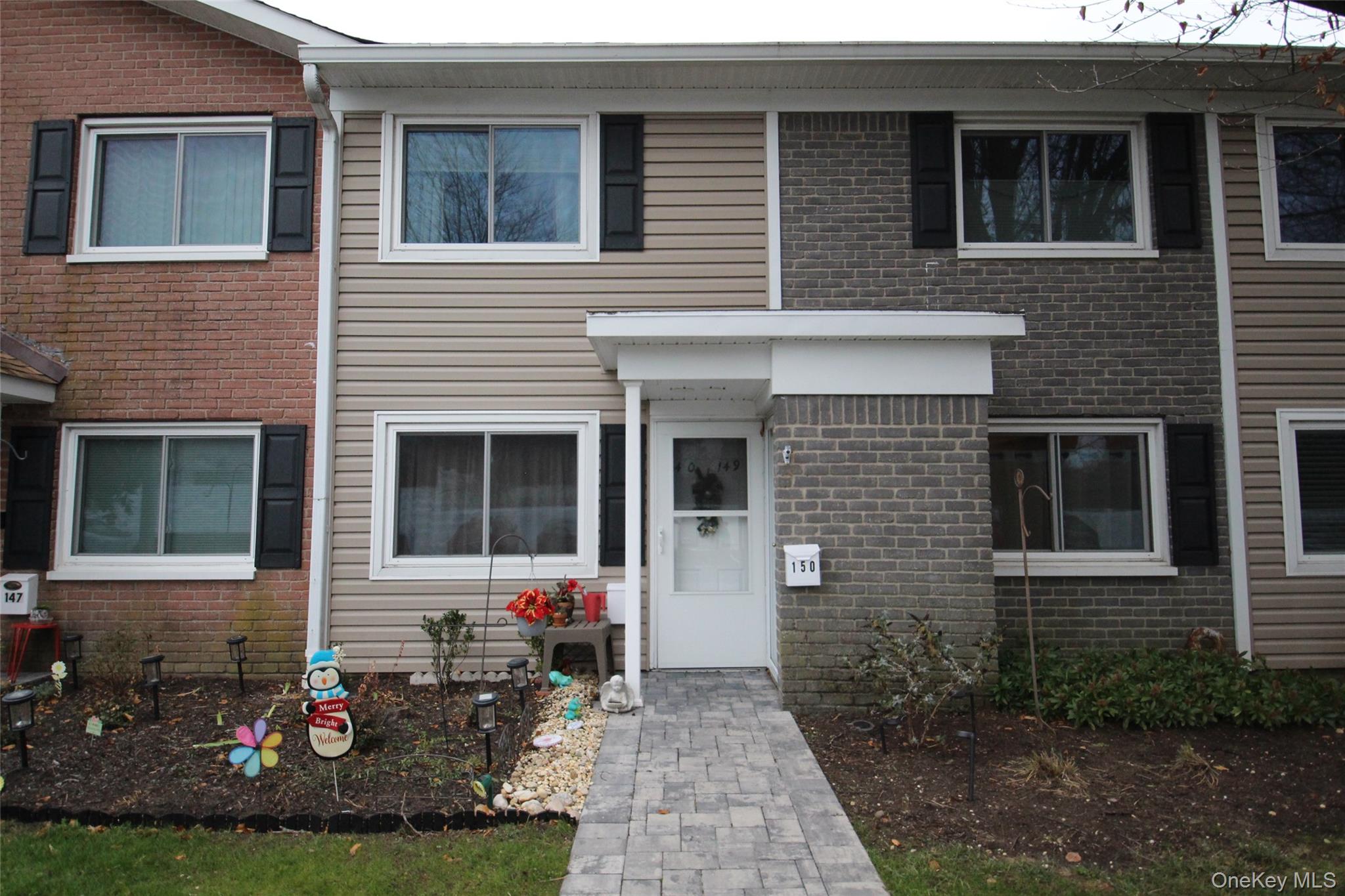 40 West 4th Street, Unit 149 Patchogue, NY 11772 - Photo 2 of 15 a view of a house with a yard
