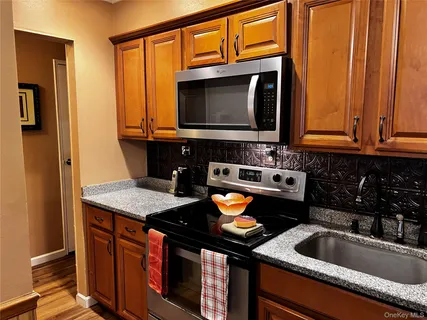 a kitchen with a sink stove and microwave