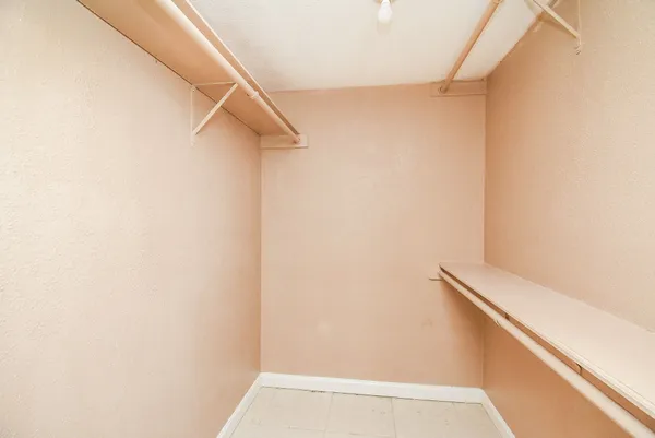 a view of staircase with railing and white walls