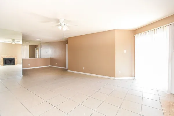 a view of a livingroom with a ceiling fan and window