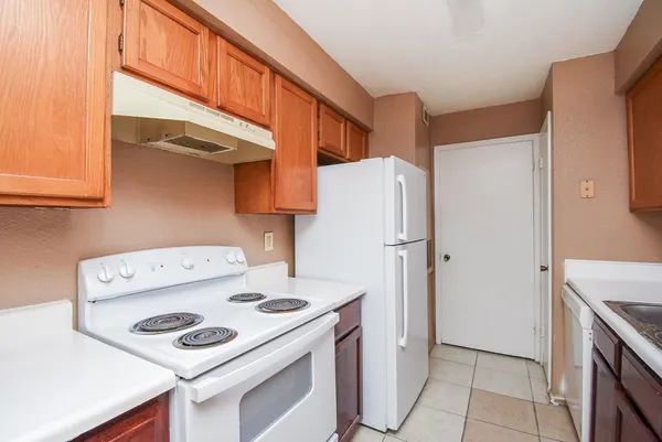 a kitchen with a stove a refrigerator and a cabinets