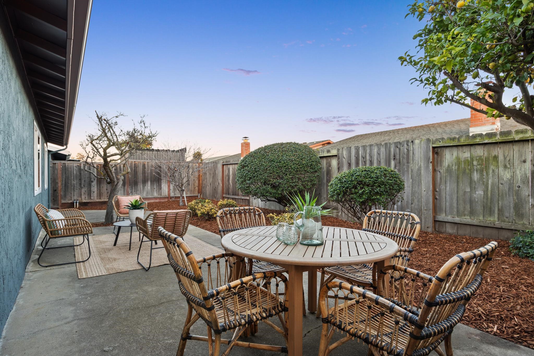 400 Harbor Light Road Alameda, CA 94501 - Photo 47 of 58 a patio with a table and chairs and a fire pit with wooden fence