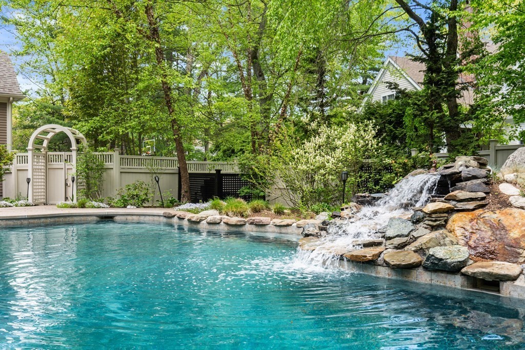 123 Country Way Needham, MA 02492 - Photo 28 of 35 a view of a lake with lawn chairs and large trees