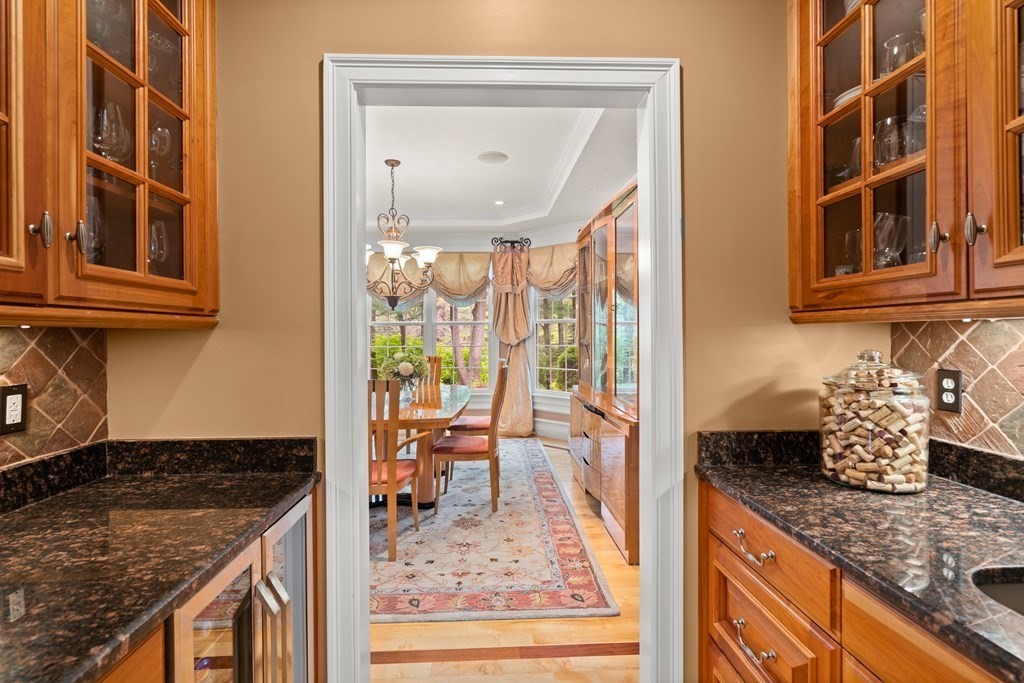 123 Country Way Needham, MA 02492 - Photo 6 of 35 a kitchen with granite countertop a stove and a dining table