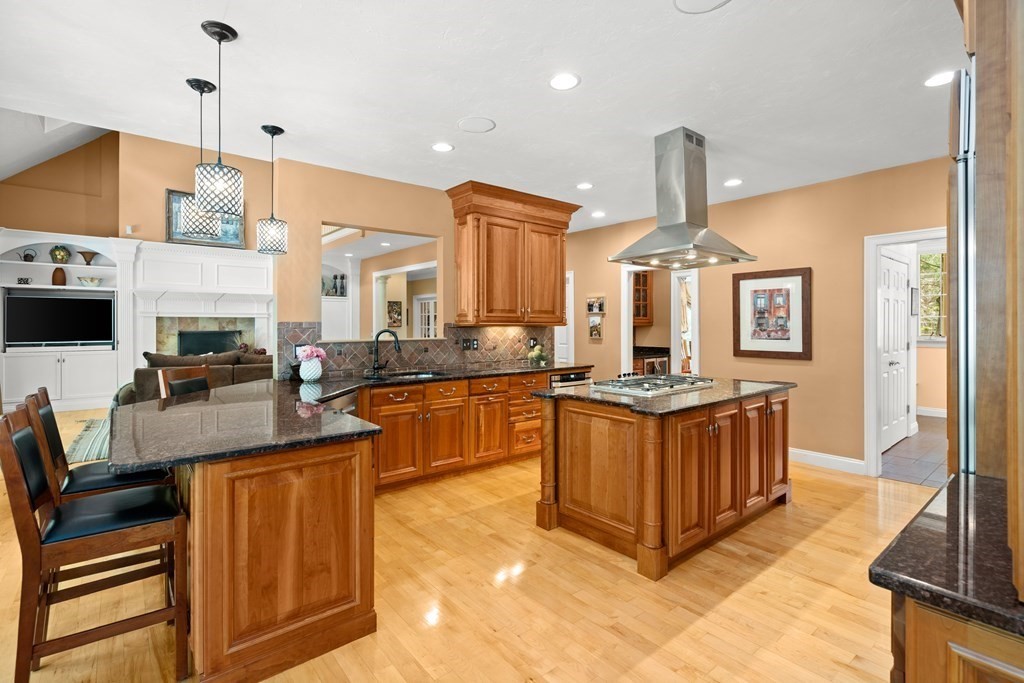 123 Country Way Needham, MA 02492 - Photo 9 of 35 a kitchen with stainless steel appliances granite countertop a stove a sink dishwasher and a refrigerator with wooden floor