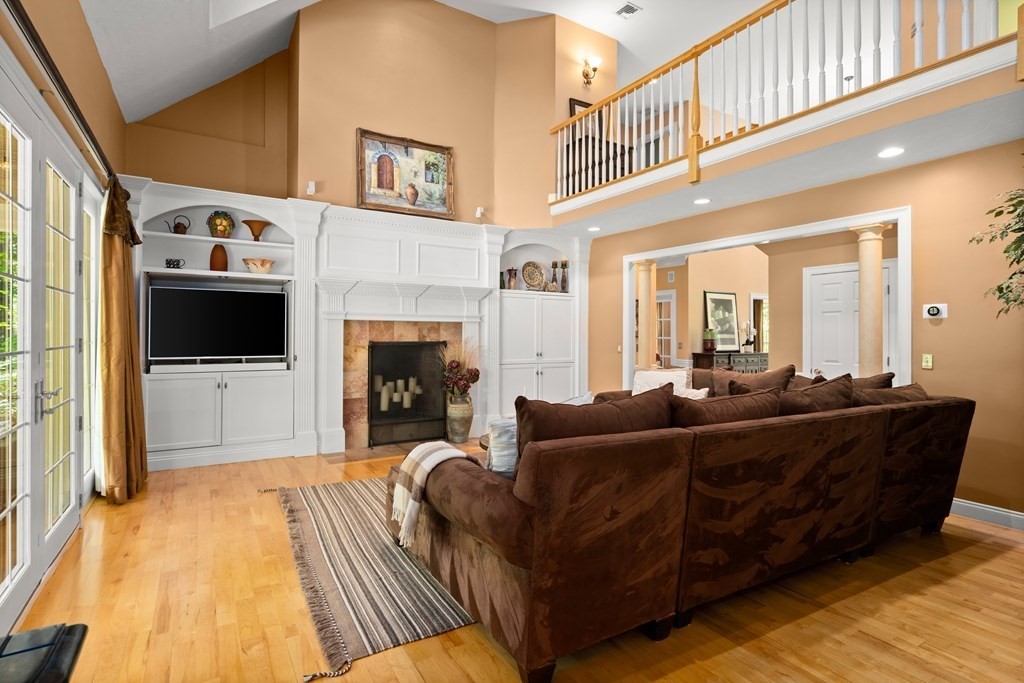 123 Country Way Needham, MA 02492 - Photo 10 of 35 a living room with furniture a flat screen tv and a fireplace