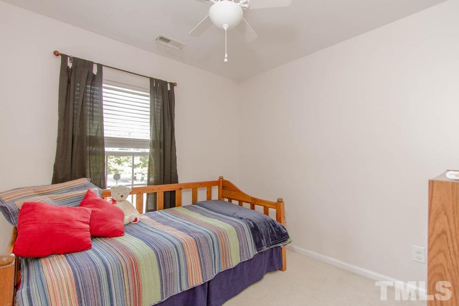 8147 Rhiannon Road Raleigh, NC 27613 - Photo 14 of 19 a bedroom with a bed and a window