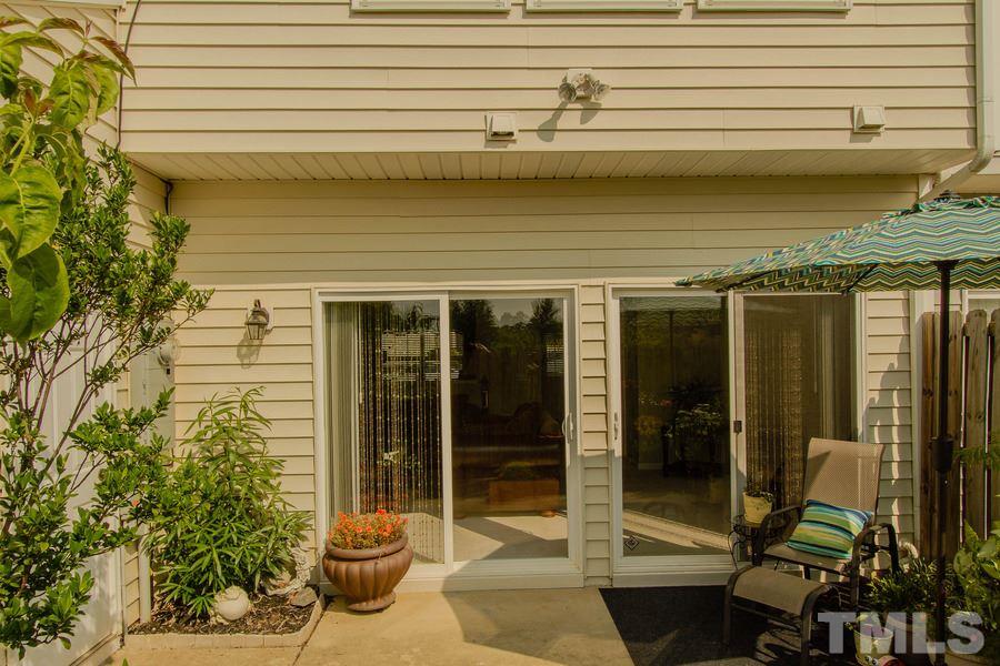8147 Rhiannon Road Raleigh, NC 27613 - Photo 17 of 19 a view of a porch with a table and chairs