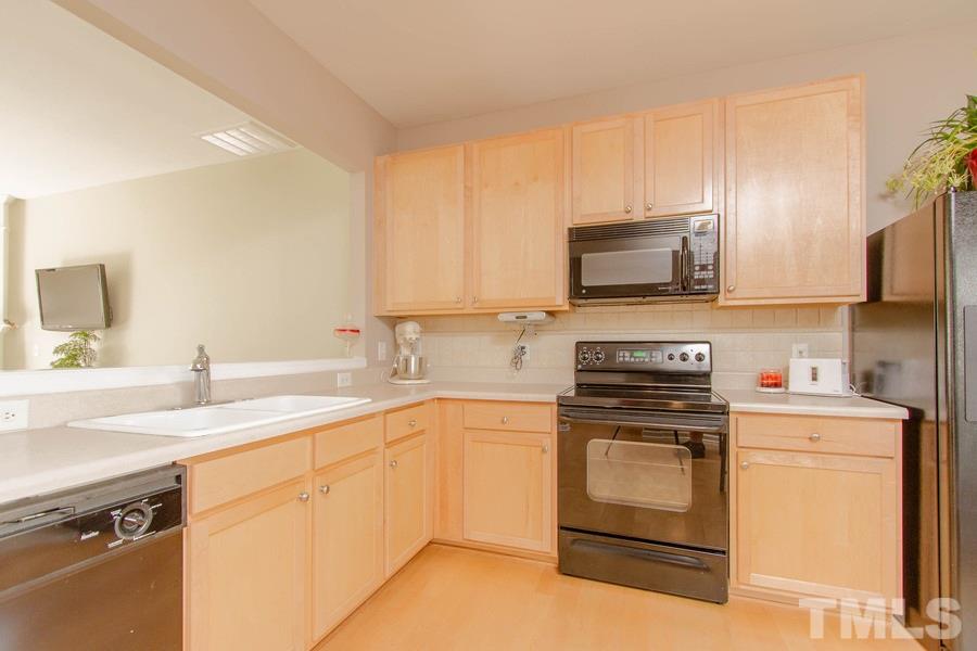 8147 Rhiannon Road Raleigh, NC 27613 - Photo 5 of 19 a kitchen with a sink stove and microwave