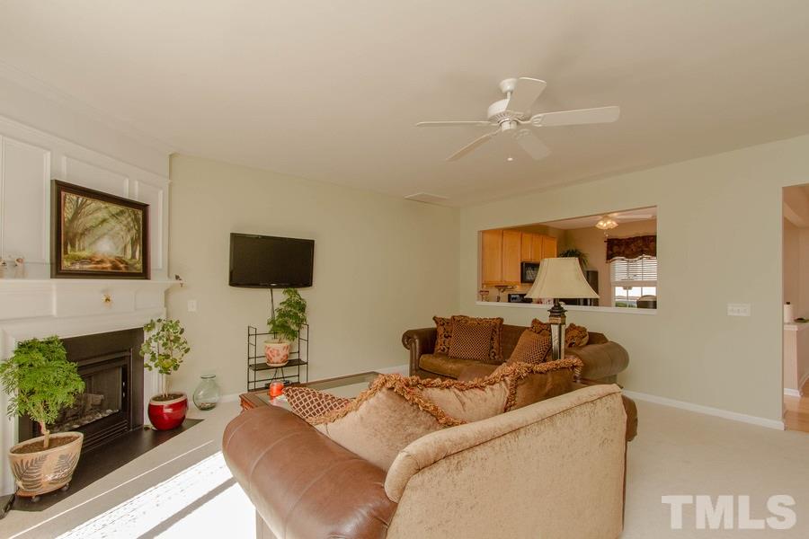 8147 Rhiannon Road Raleigh, NC 27613 - Photo 9 of 19 a living room with furniture and a flat screen tv