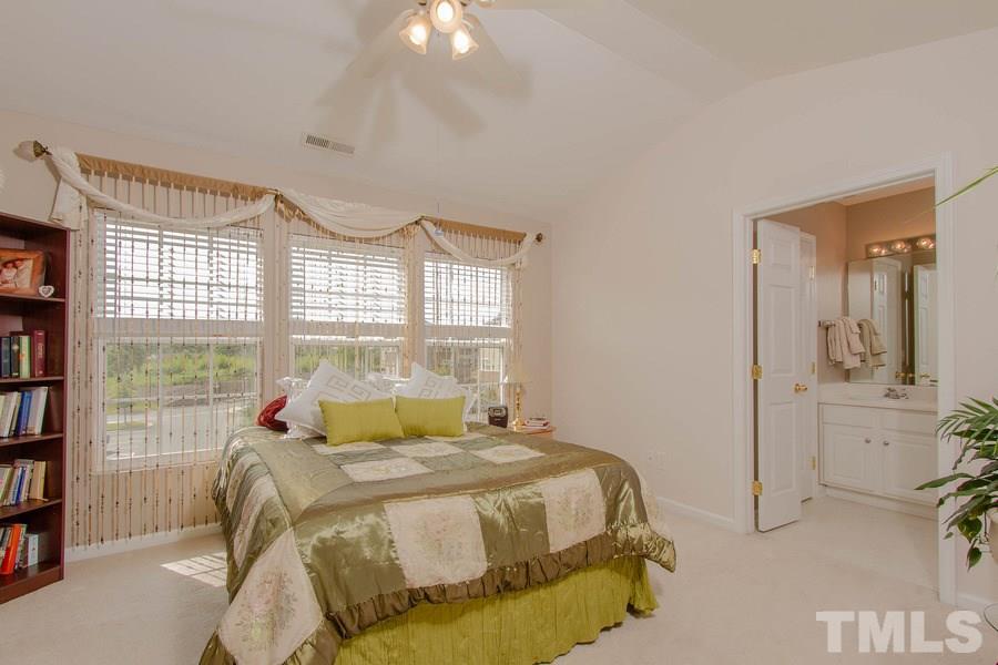 8147 Rhiannon Road Raleigh, NC 27613 - Photo 10 of 19 a bedroom with a bed and a cabinets