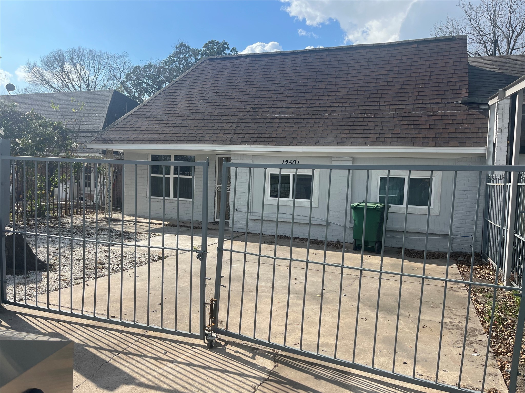 a view of a house with a wooden fence