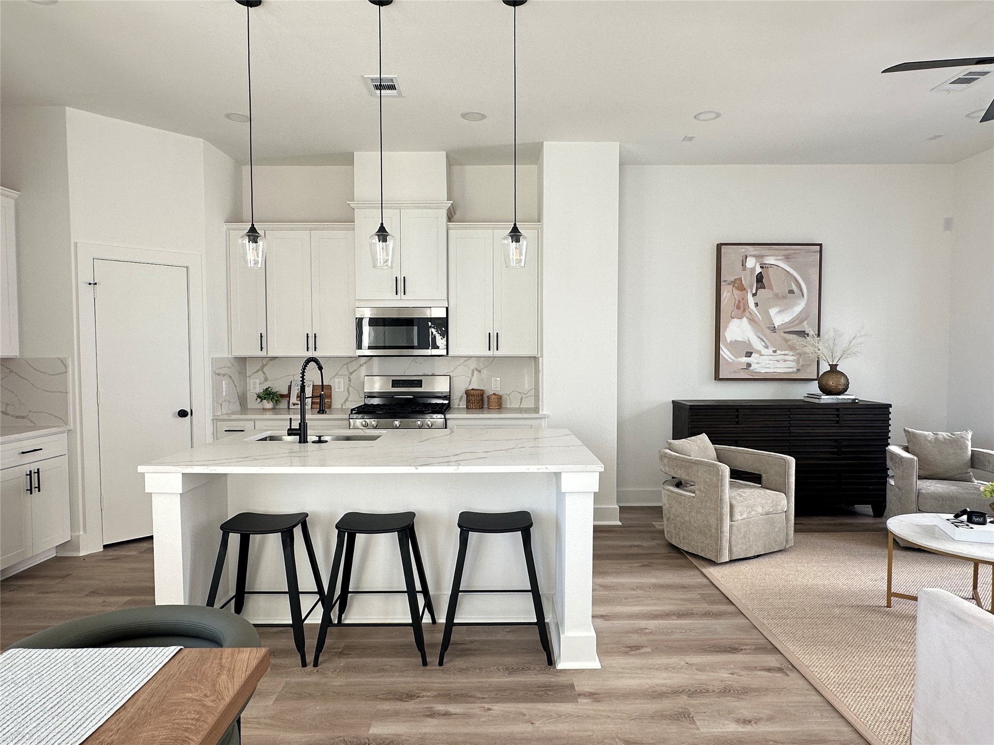 810 Elkhart Street, Unit B Houston, TX 77091 - Photo 17 of 50 a kitchen with stainless steel appliances granite countertop a dining table chairs refrigerator and sink