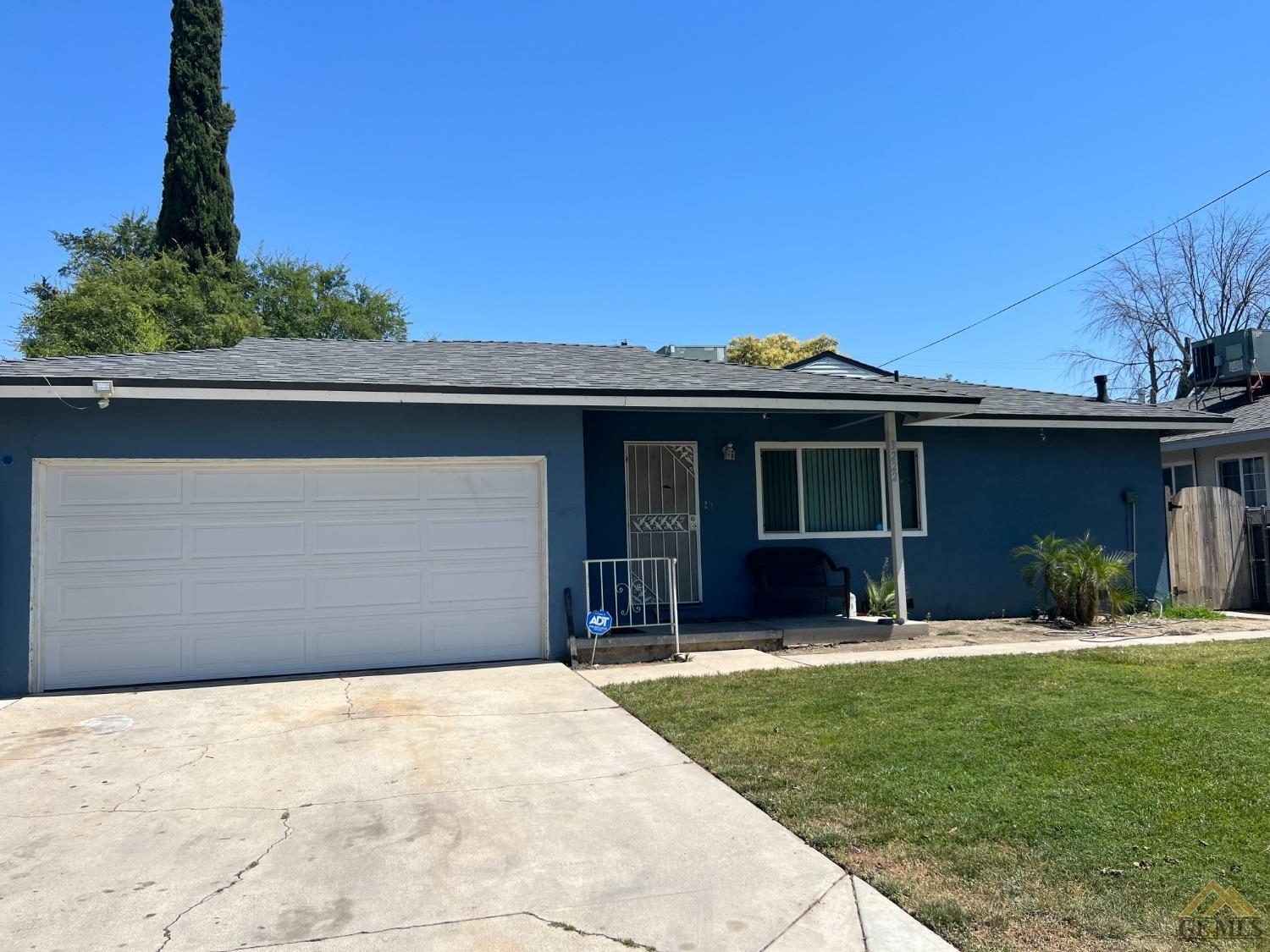 a front view of a house with a garden and yard