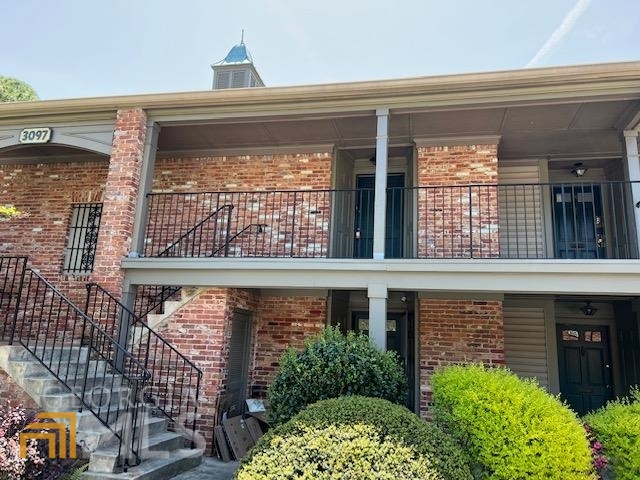 a view of a brick house with large windows