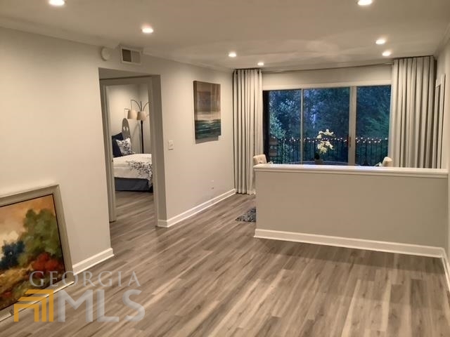 3097 Colonial Way, Unit M Chamblee, GA 30341 - Photo 11 of 11 a view of a hallway with wooden floor and furniture