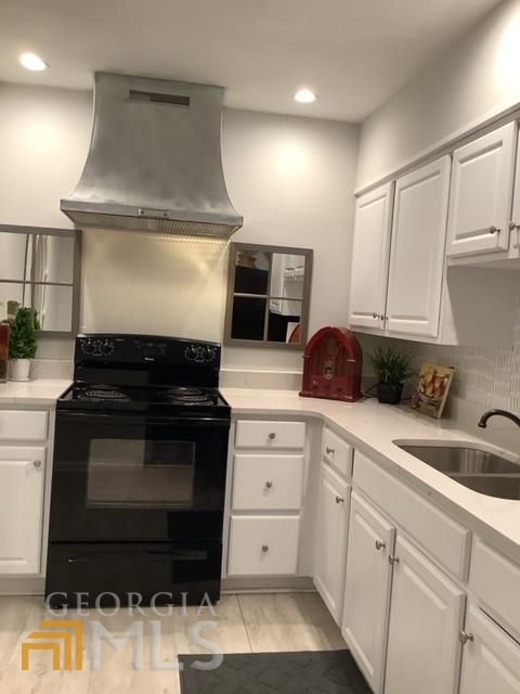 3097 Colonial Way, Unit M Chamblee, GA 30341 - Photo 6 of 11 a kitchen with white cabinets and appliances