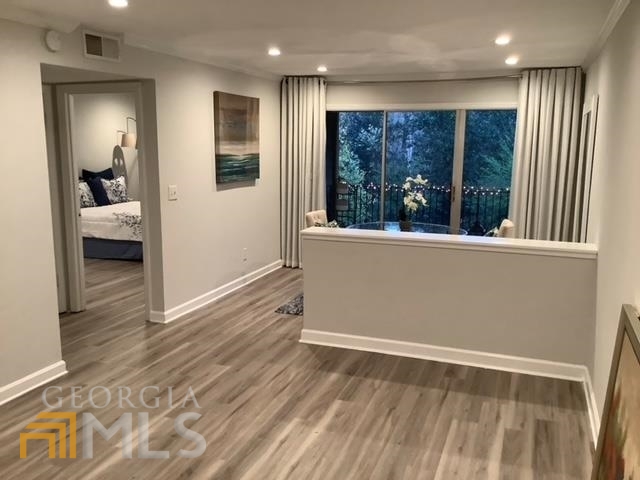 3097 Colonial Way, Unit M Chamblee, GA 30341 - Photo 8 of 11 a view of a hallway with wooden floor and windows